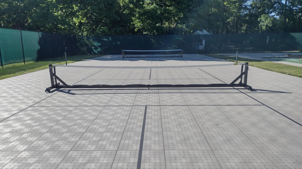 Small holes in interlocking panels used for these Pickleball Courts provide a quick-dry surface