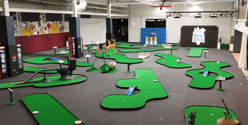 Golf holes in various shapes and sizes along with obstacles at the Barstool Chicago Mini Golf Open