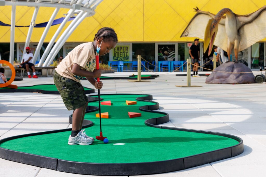 miniature golf course at a children's hospital, portable course with colorful faux wood shapes
