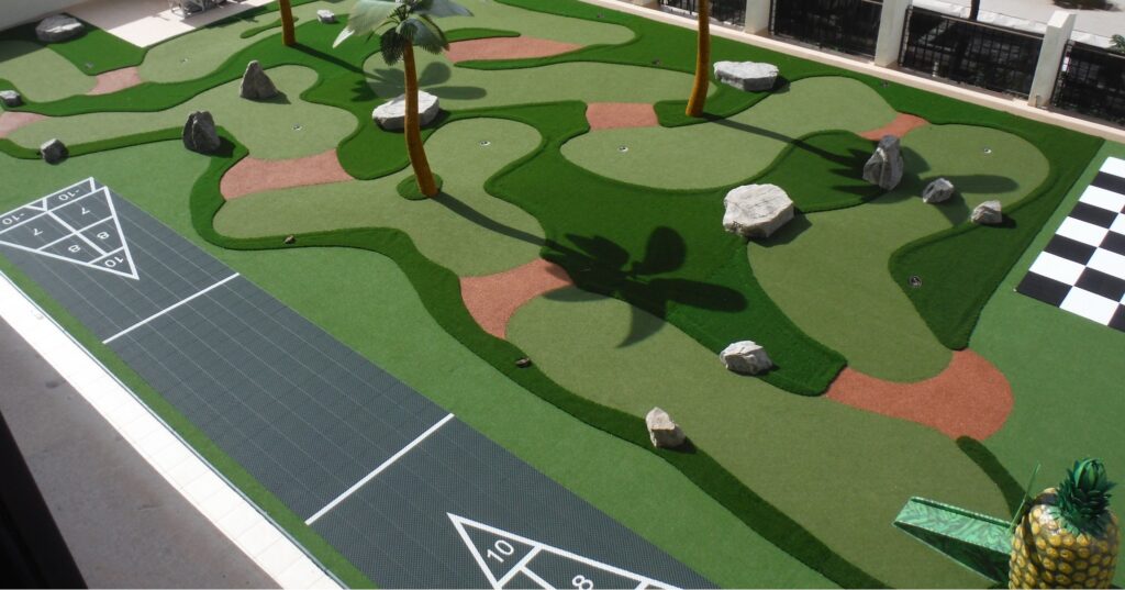 miniature golf course atop the roof of a holiday inn express - features faux palm trees, shuffleboard, and life-sized checkers/chess