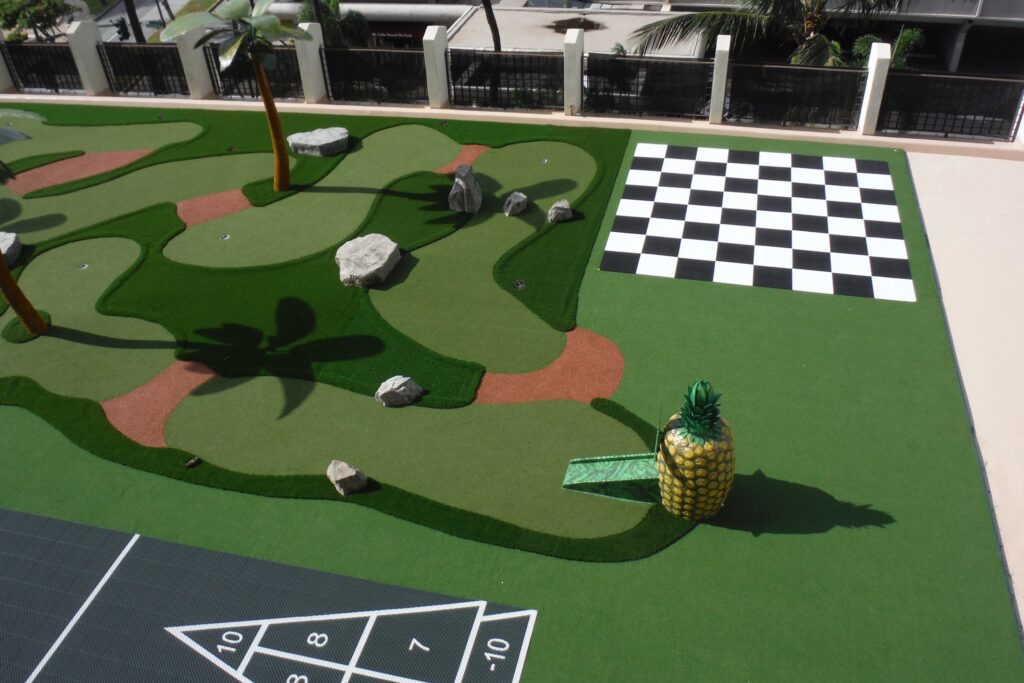 life sized chess/checkers alongside miniature golf course atop the roof of a hotel