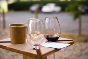 Cups and stemmed wine glasses fit in the slots of this small counter height table at each golf hole