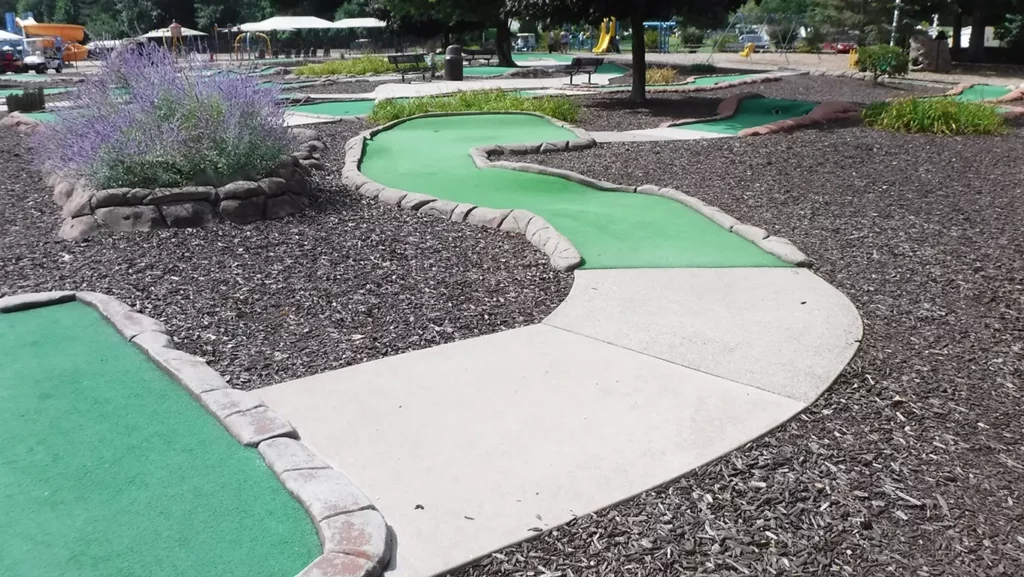 This Sandy Pines mini golf hole with a dogleg right had worn turf and a non-challenging cup location