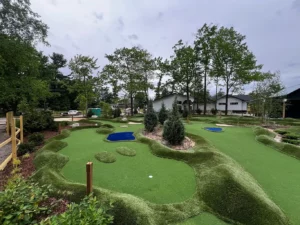 ADA compliant mini golf holes are wheelchair accessible with minimal slopes and low-impact obstacles