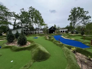 Mini golf course holes in front of the outdoor amphitheater and restaurant at River Club Glen Arbor