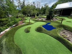 Looking down several contoured mini golf holes at different elevations at River Club Glen Arbor