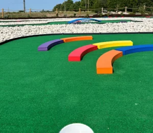 Curved bars on mini golf holes either help putting for a hole-in-one or increase the challenge