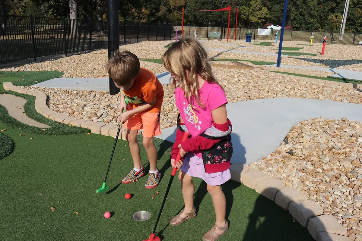 Children putting at the new 18-hole ADA compliant mini-golf course at the City of Pittsburg, KS