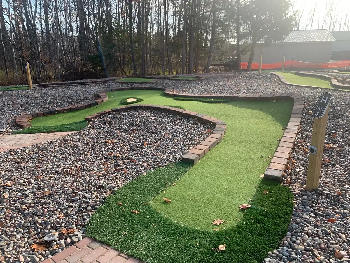 This dogleg par-4 mini-golf hole with faux sand trap and slopes at Sherwood Forest is challenging